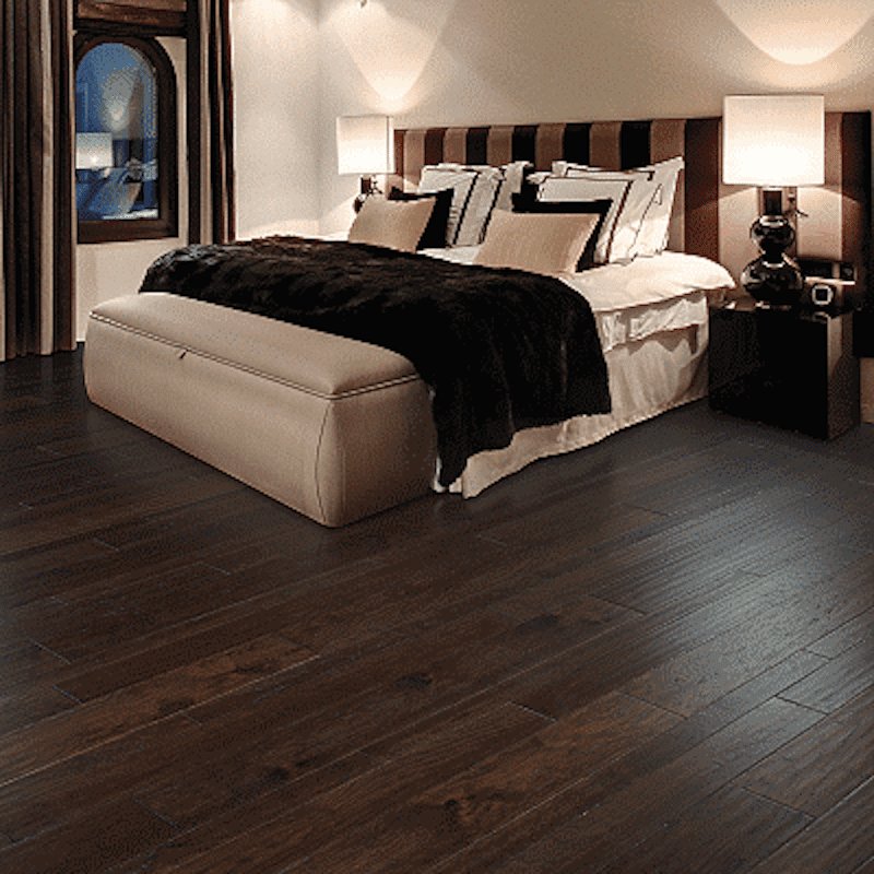 Dark hardwood flooring in an elegant bedroom